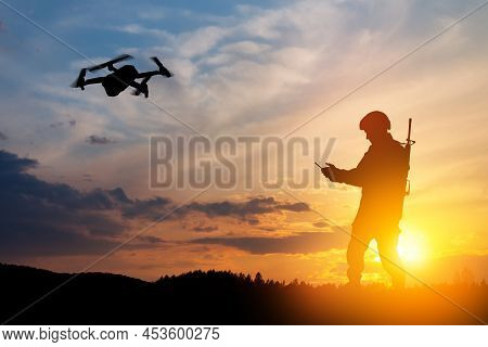 Silhouette Of Soldier Are Using Drone And Laptop Computer For Scouting During Military Operation.