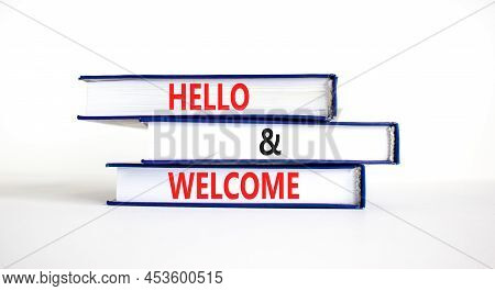 Hello And Welcome Symbol. Concept Words Hello And Welcome On Books. Beautiful White Table White Back