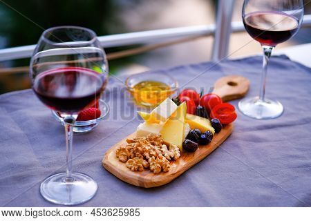 Two Glasses Of Wine And Cheese Plate. Aperetif.