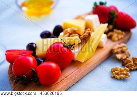 Two Glasses Of Wine And Cheese Plate. Aperetif.