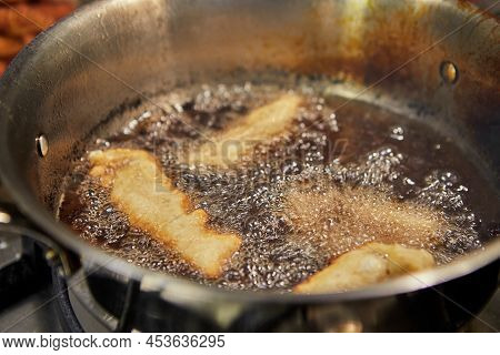 Bugnes, French Donuts In Boiling Oil In Saucepan