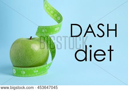 Dash Diet To Stop Hypertension. Ripe Green Apple And Measuring Tape On Light Blue Background
