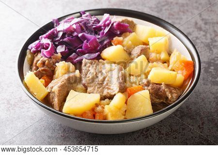 Scouse Is A Stew With Meat And Vegetables Served With Pickled Cabbage Close-up In A Plate On The Tab