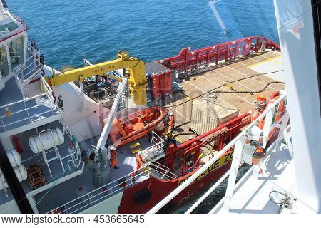 Red Hulled Standby Safety Vessel In Ship To Ship Operation. It Is Used To Refuel And Resupply Seismi