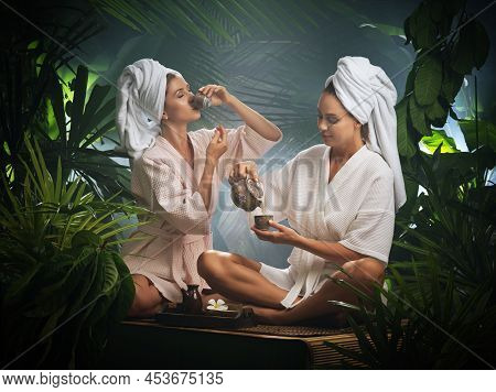 Portrait Of Young Beautiful Women Drinking Tea  In Spa Environment.