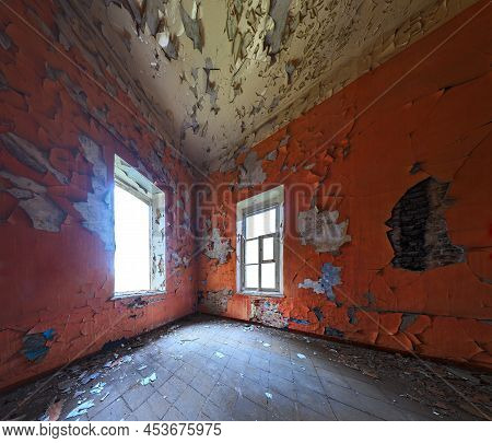 Abandoned Interior With Two Windows In Corner. Orange Wall Color. Wide Angle Shot.