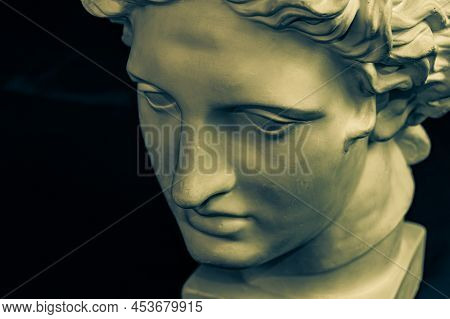 Bronze Color Gypsum Copy Of Ancient Statue Apollo God Of Sun And Poetry Head For Artists On Dark Bac