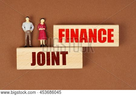Business And People Concept. On Wooden Blocks With The Inscription - Finance Joint, There Are Miniat