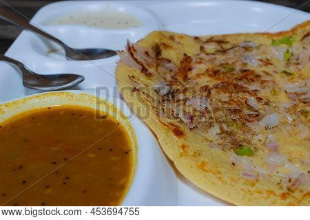 Uttapam Is Served With Chutney On White Plate, Indian Vegetable Dish.