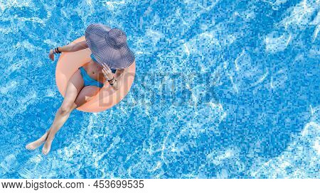 Beautiful Woman In Hat In Swimming Pool Aerial Top View From Above, Young Girl In Bikini Relaxes And