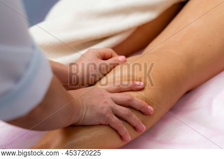 Facial Massage. A Woman Is Given A Massage In A Beauty Salon. Close-up.