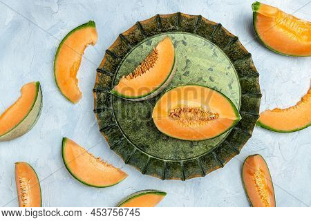 Cantaloupe Melon. Whole And Slice Of Japanese Melons, Orange Melon With Seeds On Light Background. P