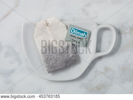 London, Uk - October 21, 2020: Dilmah Earl Grey Tea Bag On Ceramic Plate With Cup Shape On White Bac