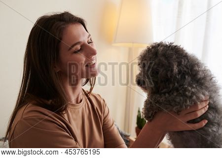Happy Woman Interacting With Dog, That Helps Relieve Stresss, Anxiety And Calms Emotional Wellbeing
