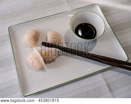 Dim Sum Or Har Gow Shrimp Dumpling With Chopsticks And Soy Sauce, Also Anglizised As Ha Gow, Haukau 