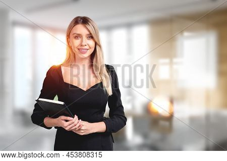 Young Attractive Businesswoman Wearing Formal Wear Is Standing Holding Notebook At Office Workplace 