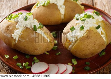 Boiled Jacket Potatoes Stuffed With Cottage Cheese, Sour Cream And Green Onions Close-up In A Plate 