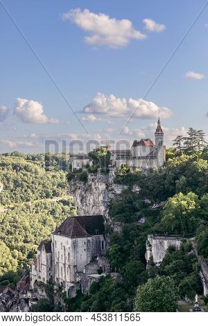 Group Of Massive Religious Buildings Half-way Up Cliff And Castle On summit Of Medieval Historical V