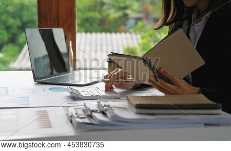 Financial Advisor Calculating Numbers Datasheets Graphs Charts Reports Marketing Research Developmen