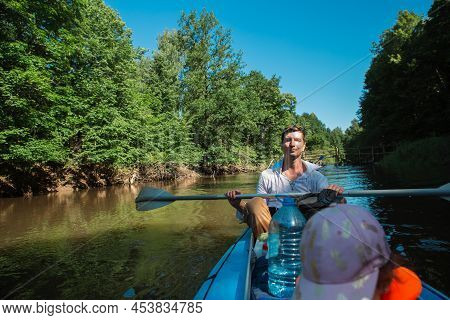Family Kayak Trip. Father And Daughter, And Elderly Couple Senior And Seniora Rowing Boat On The Riv