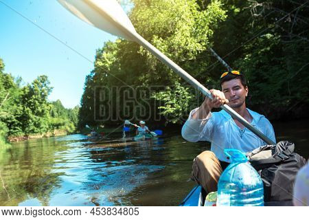 Family Kayak Trip. Father And Daughter, And Elderly Couple Senior And Seniora Rowing Boat On The Riv