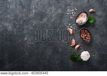 Black Food Cooking Background. Stone Texture With Sea Salt, Pepper Garlic And Parsley. Abstract Food