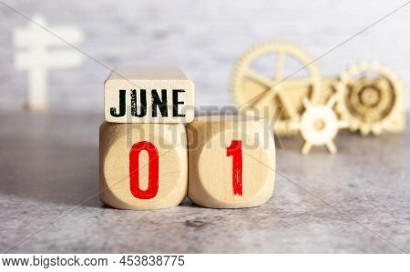 June 1 On A Wooden Calendar On A Light Background With Flowers. First Day Of Summer. Empty Space For