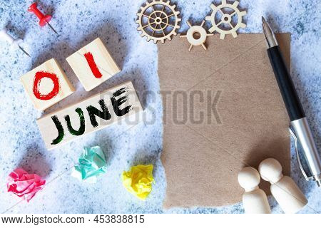 June 1 On A Small White Notebook .next To It Is A Pot With A Cactus, Paper Clips Are Scattered.
