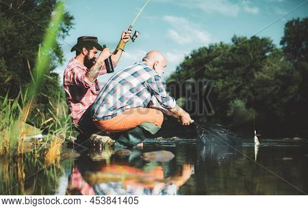 Big Game Fishing. Summer Weekend. Two Fishermen Relaxing Together With Beer While Fishing On Lake At