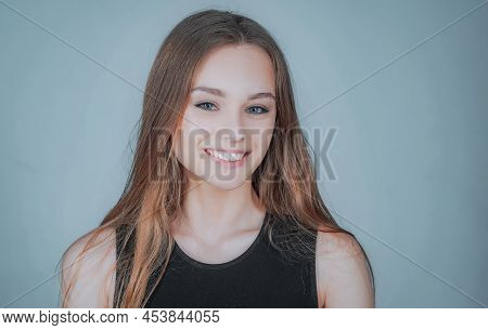 Portrait Of A Cute Blonde Girl Standing On White Background. Close Up Portrait Of Young Cheerful Bea