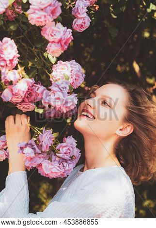 Pink Rosebush Blooming. Happy Woman Walking At Rose Garden. Relaxing And Happiness Concept. Young Sm