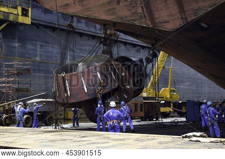 Sembawang, Singapore - Mar 2 2013: Sembawang Ship Yard Workers Changing Stern Nozzle Azipod Thruster
