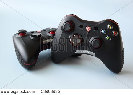 Two Msi Joystick Gaming Controller On Light Blue Background.