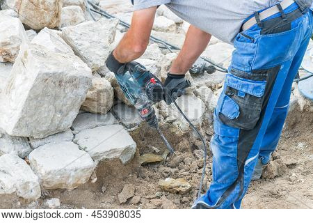 Construction Worker Is Working With Granite Stones