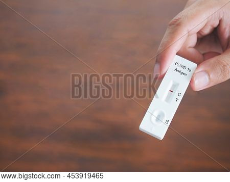 Human Hand Holding Atk Or Antigent Test Kit Showing  Positive For Protection Covid-19 Coronavirus Ov