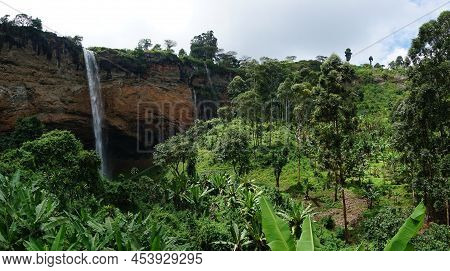 Lush Tropical Forest With One Of The Sipi Falls In The Background, Eastern Uganda