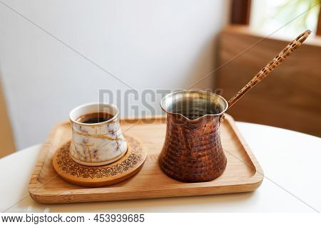 Coffee Table With Cup Cezva And Coffee Grinder In The Cafe