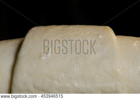 Uncooked Croissant On Tray In Electric Oven - Close Up Macro View, Black Background. French Cuisine,