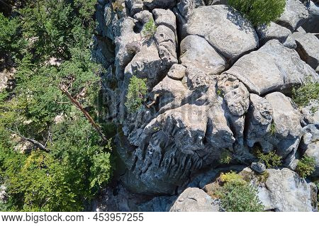 Aerial View Of Large Rocky Formations With Snone Boulders And Mountain High Cliffs