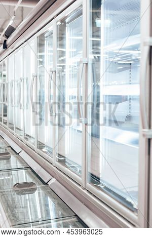 Empty Refrigerator Or Freezer For Food And Grocery Items In Store. Selective Focus, Vertical Photo.