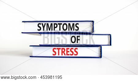 Symptoms Of Stress Symbol. Concept Words Symptoms Of Stress On Books. Beautiful White Table White Ba