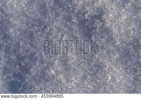 Macro Photo Of Snow-covered Land, Snowflakes On A Cold Winter Day. The Snow Cover In Close-up Is An 