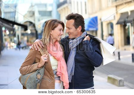 Middle-aged couple doing shopping on week-end