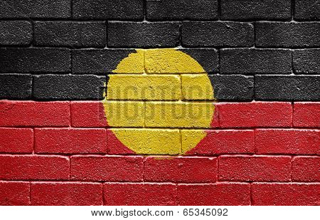 Flag of Aborigines painted onto a grunge brick wall
