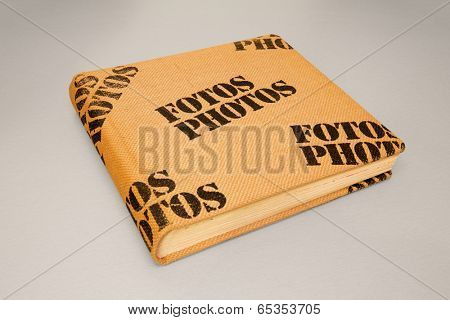 Photo album cover made from burlap with stamped on terms Fotos and Photos on it
