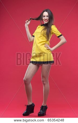 Woman standing on red background