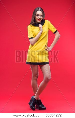 Woman standing on red background