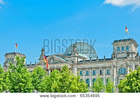 German Parliament with national flag in Berlin, Germany