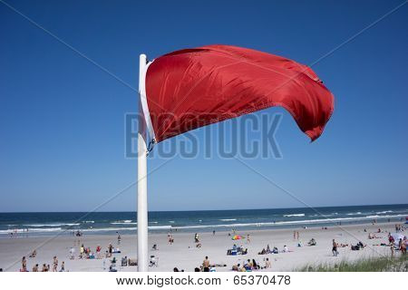 JACKSONVILLE BEACH, FL-MAY 17, 2014: Red warning flag at Jacksonville Beach on a weekend. Jacksonville Beach is 15 miles east of Jacksonville and has a population of 21,362 at the 2010 census.