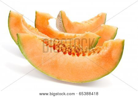 some slices of Persian melon on a white background